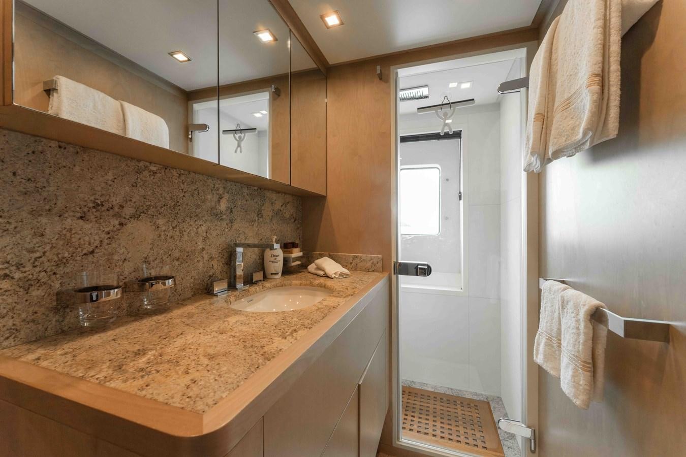 a bathroom with marble counter tops aboard COCONUTS Yacht for Sale