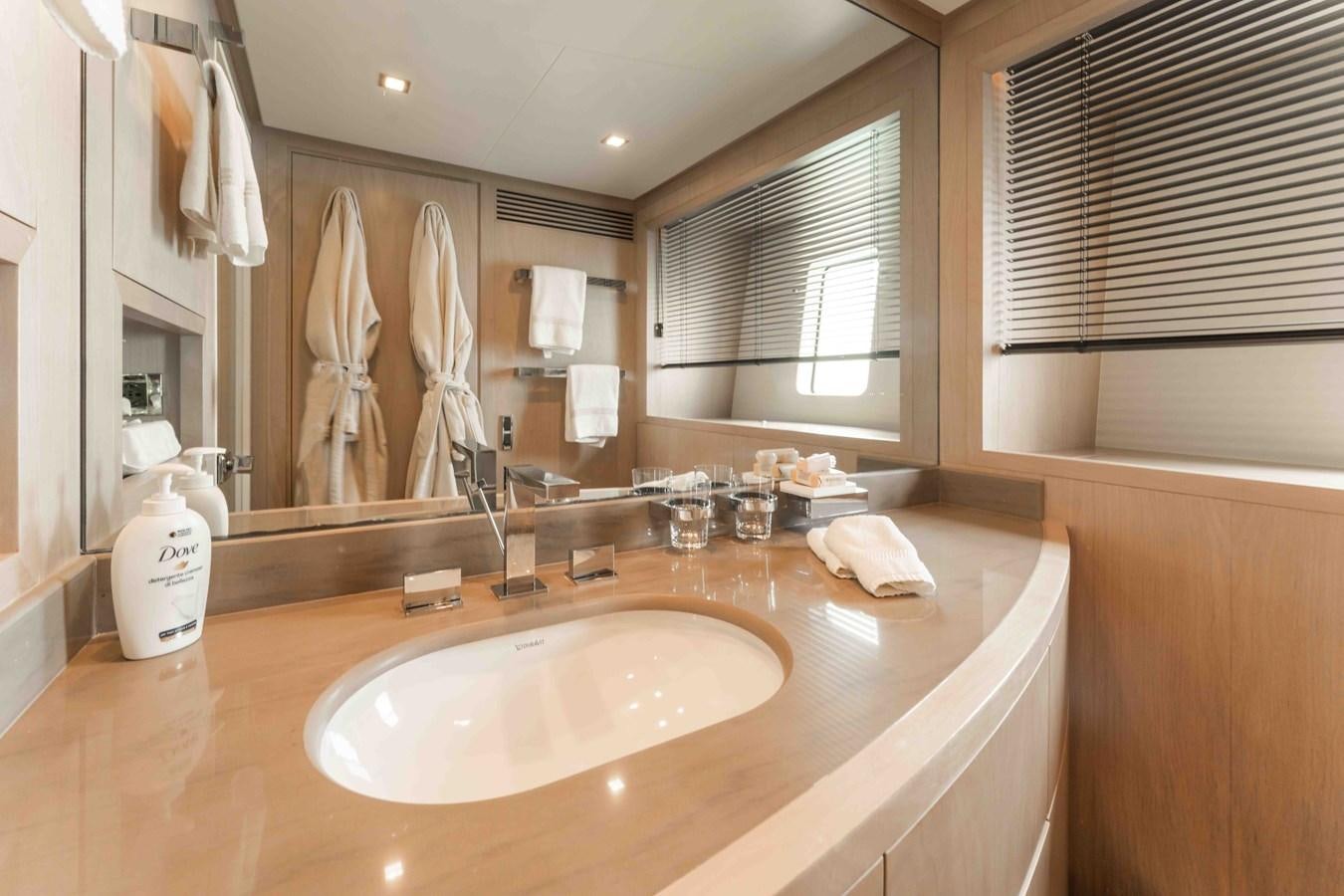 a bathroom with a large mirror aboard COCONUTS Yacht for Sale