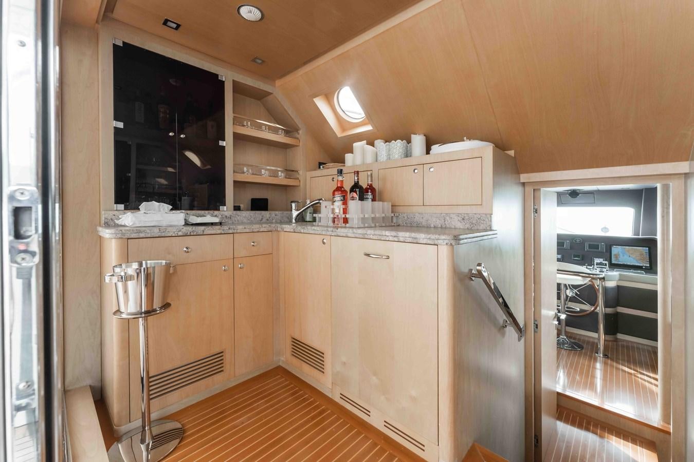 a kitchen with wooden cabinets aboard COCONUTS Yacht for Sale