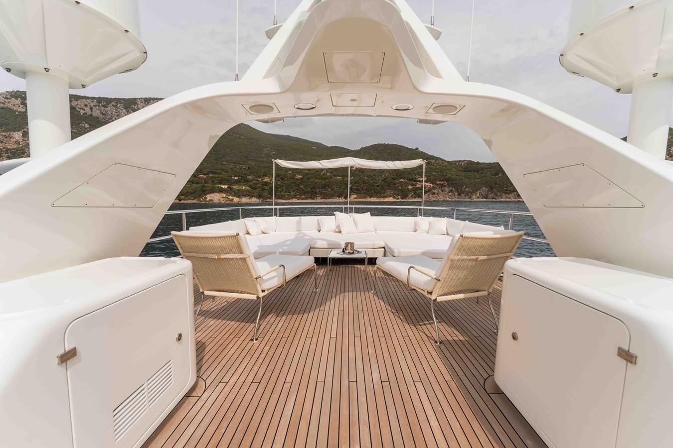 a large white tent with a grassy hill behind it aboard COCONUTS Yacht for Sale