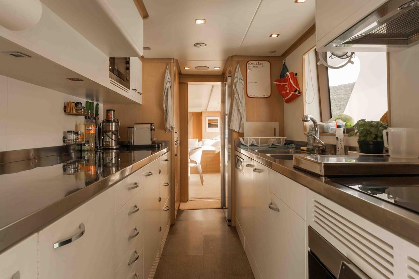 a kitchen with a large island aboard COCONUTS Yacht for Sale