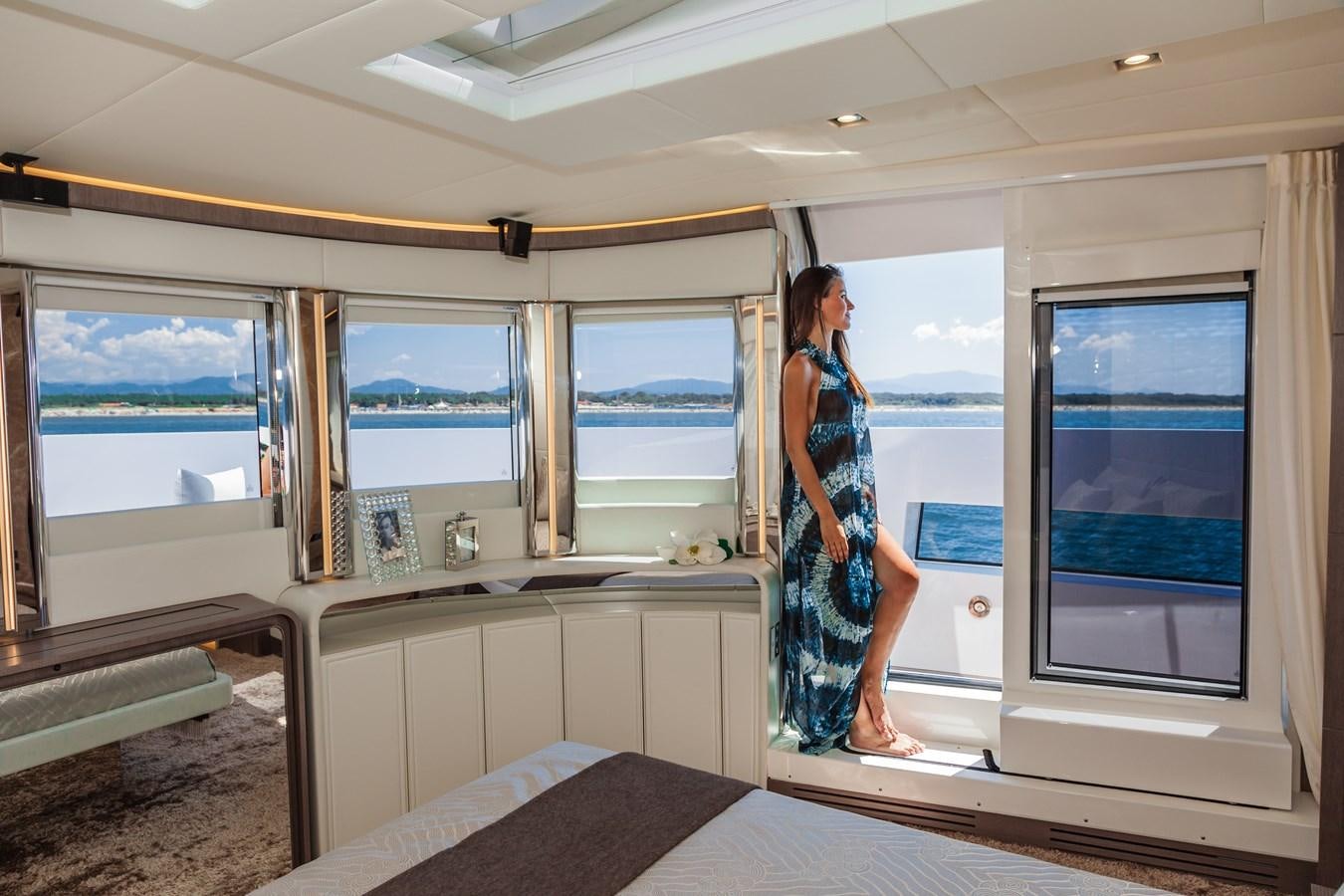 a person standing in a room looking out a window aboard DREAMLINE 35 Yacht for Sale