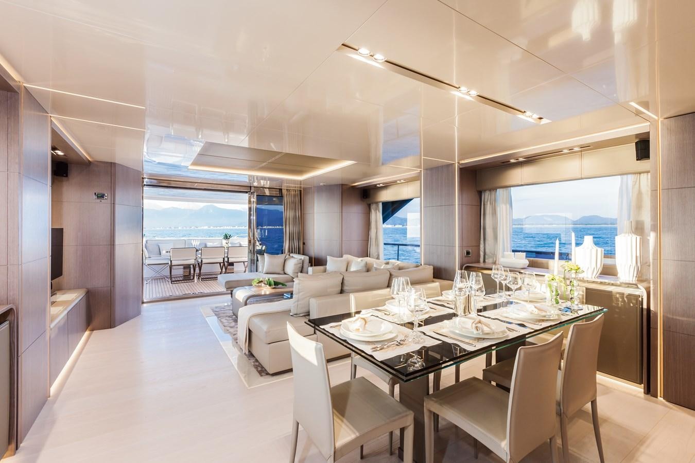 a large room with a table and chairs aboard DREAMLINE 35 Yacht for Sale