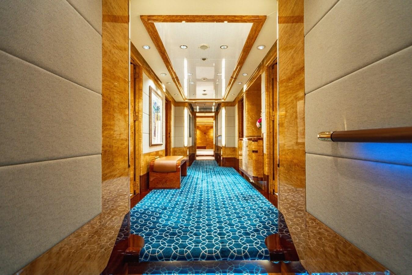a hallway with a blue rug aboard AMADEUS Yacht for Sale