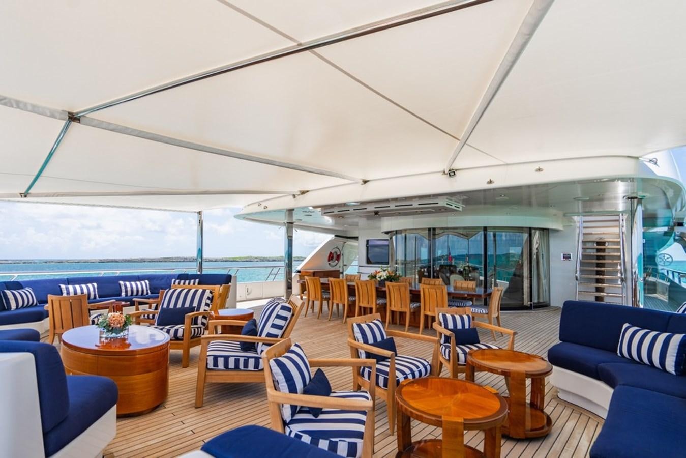 a room with tables and chairs aboard AMADEUS Yacht for Sale