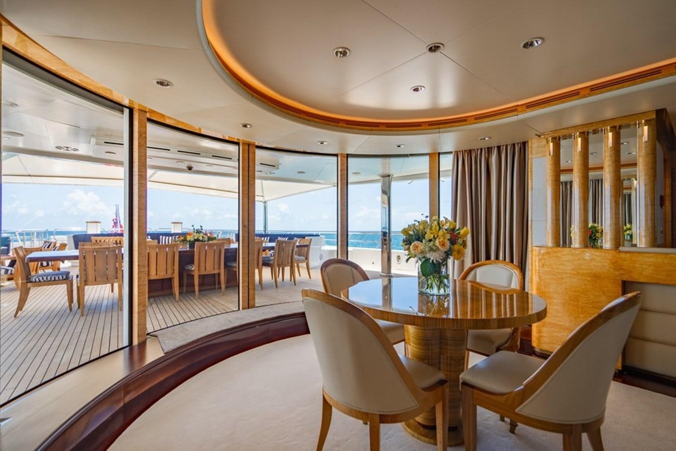 a room with tables and chairs aboard AMADEUS Yacht for Sale