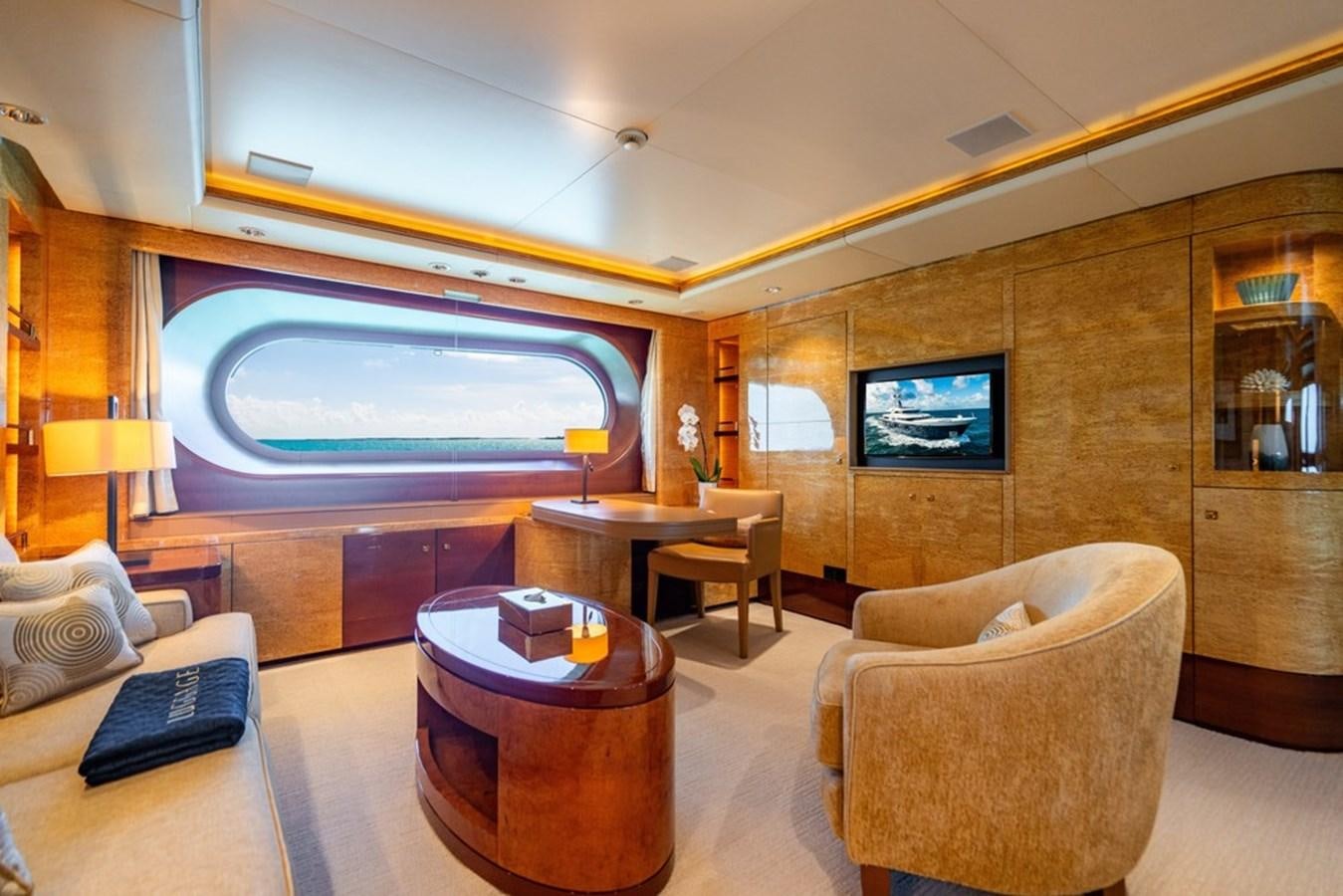 a living room with a large television aboard AMADEUS Yacht for Sale
