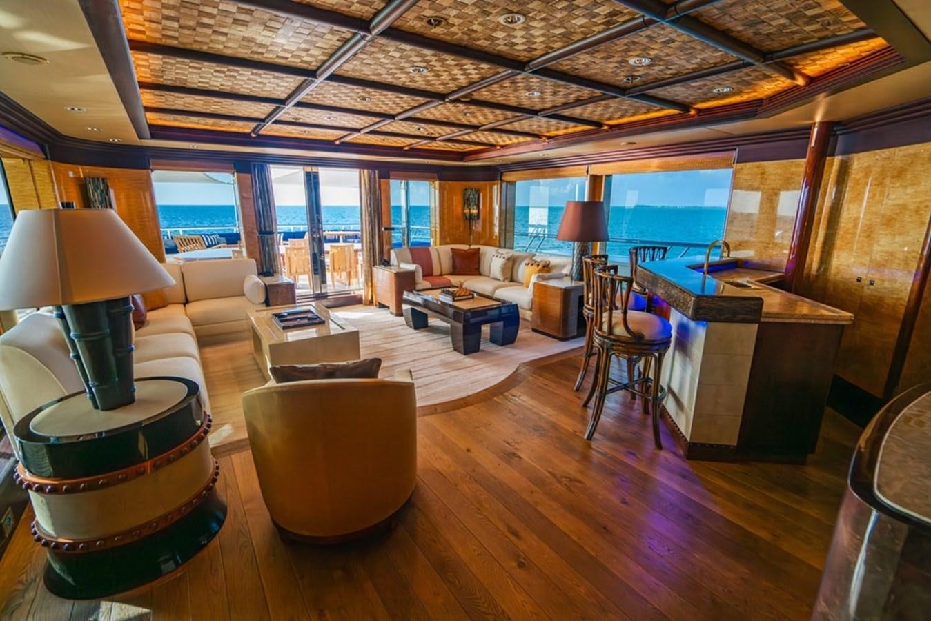 a room with a large window and a table with chairs and a large window aboard AMADEUS Yacht for Sale