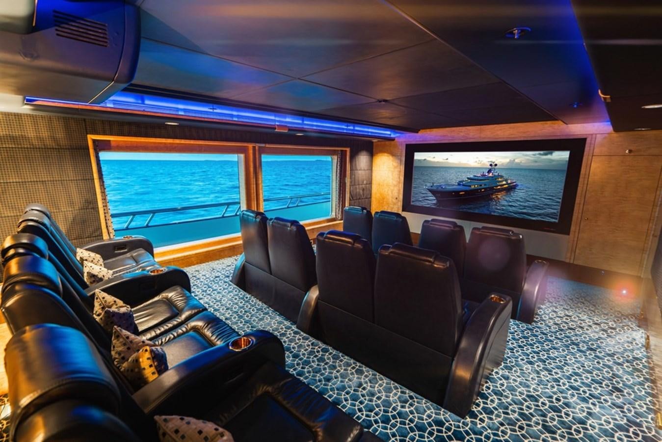 a room with a large screen and a couch and a tv aboard AMADEUS Yacht for Sale
