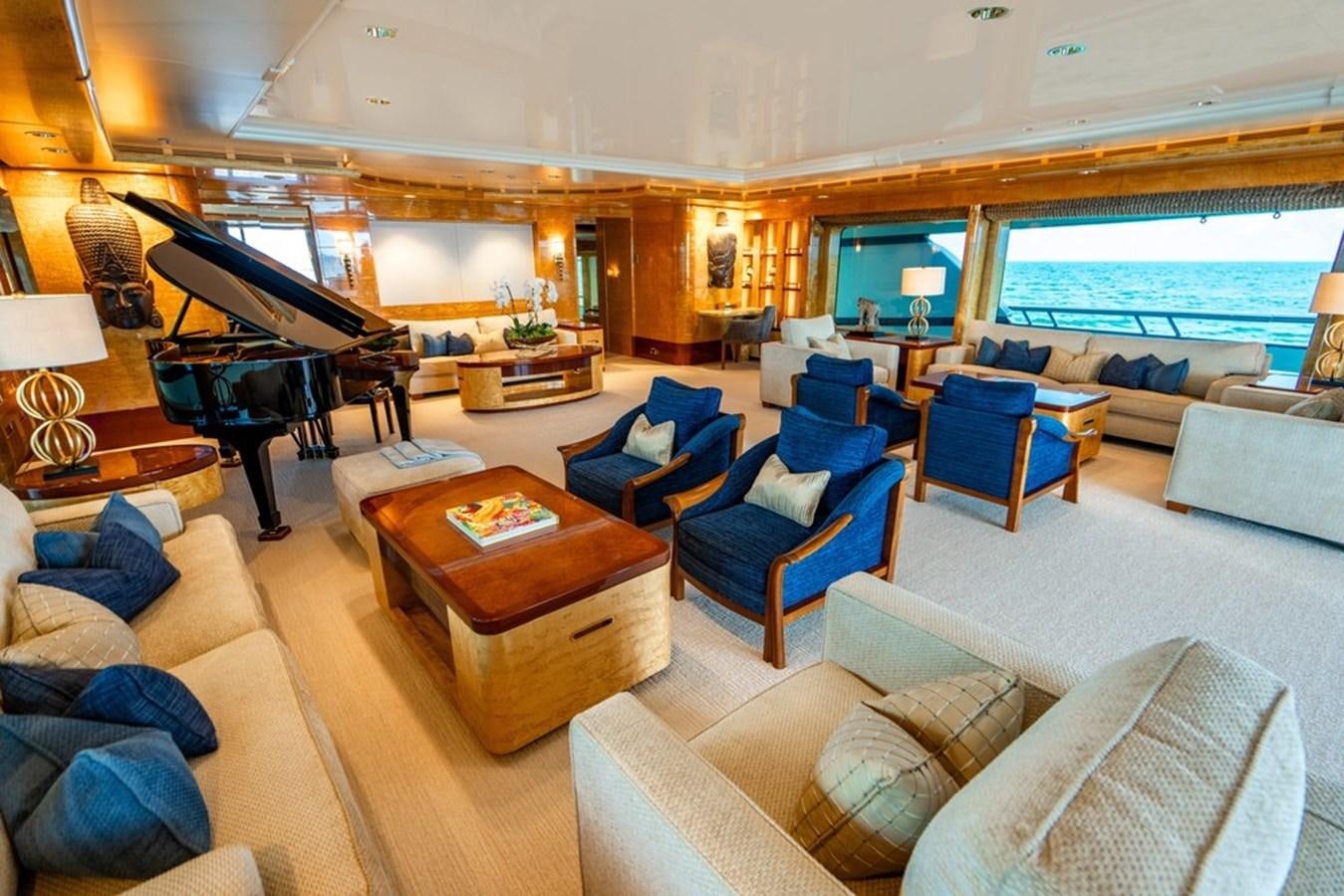a living room with a piano and a piano aboard AMADEUS Yacht for Sale