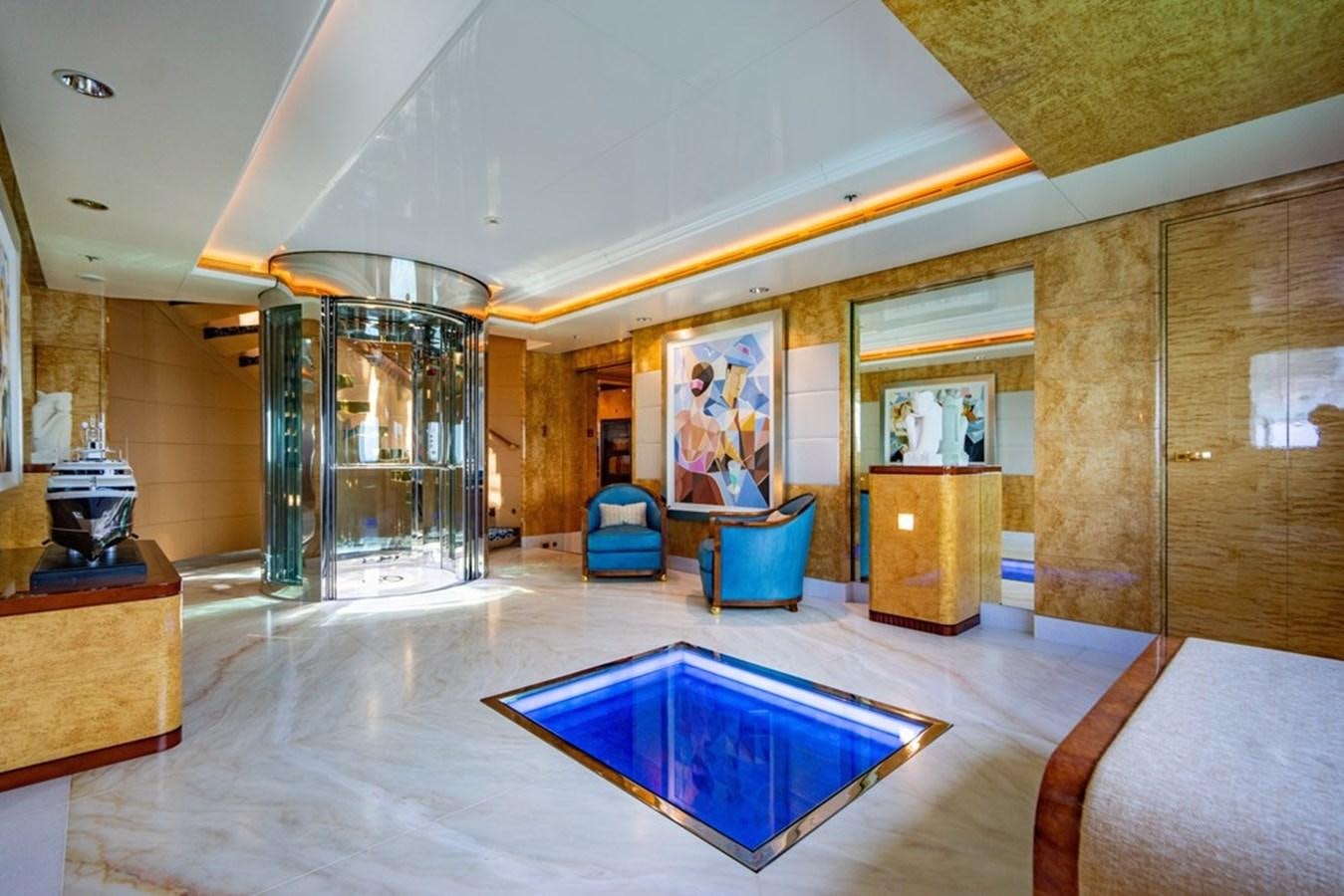 a large room with a pool table and a chair aboard AMADEUS Yacht for Sale