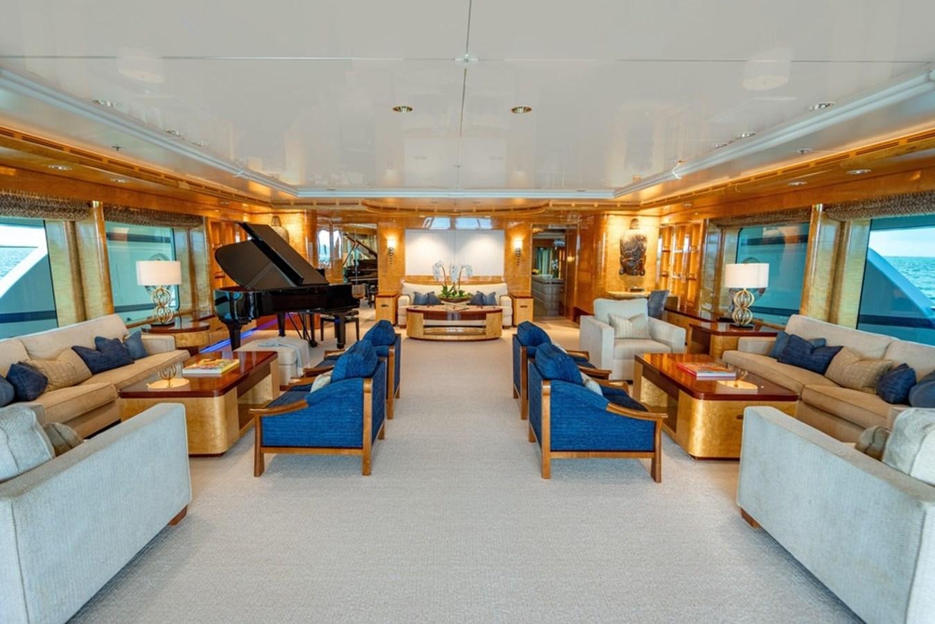 a living room with a piano and a piano aboard AMADEUS Yacht for Sale