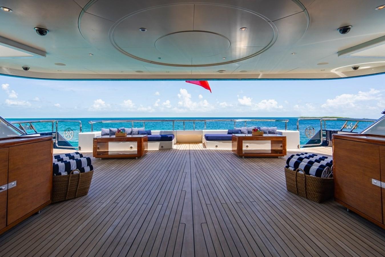 a room with a view of the ocean and a beach aboard AMADEUS Yacht for Sale