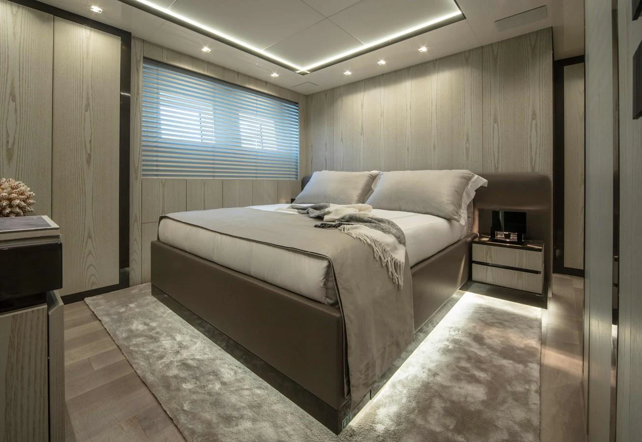 a bedroom with a bed and a desk aboard MA Yacht for Sale