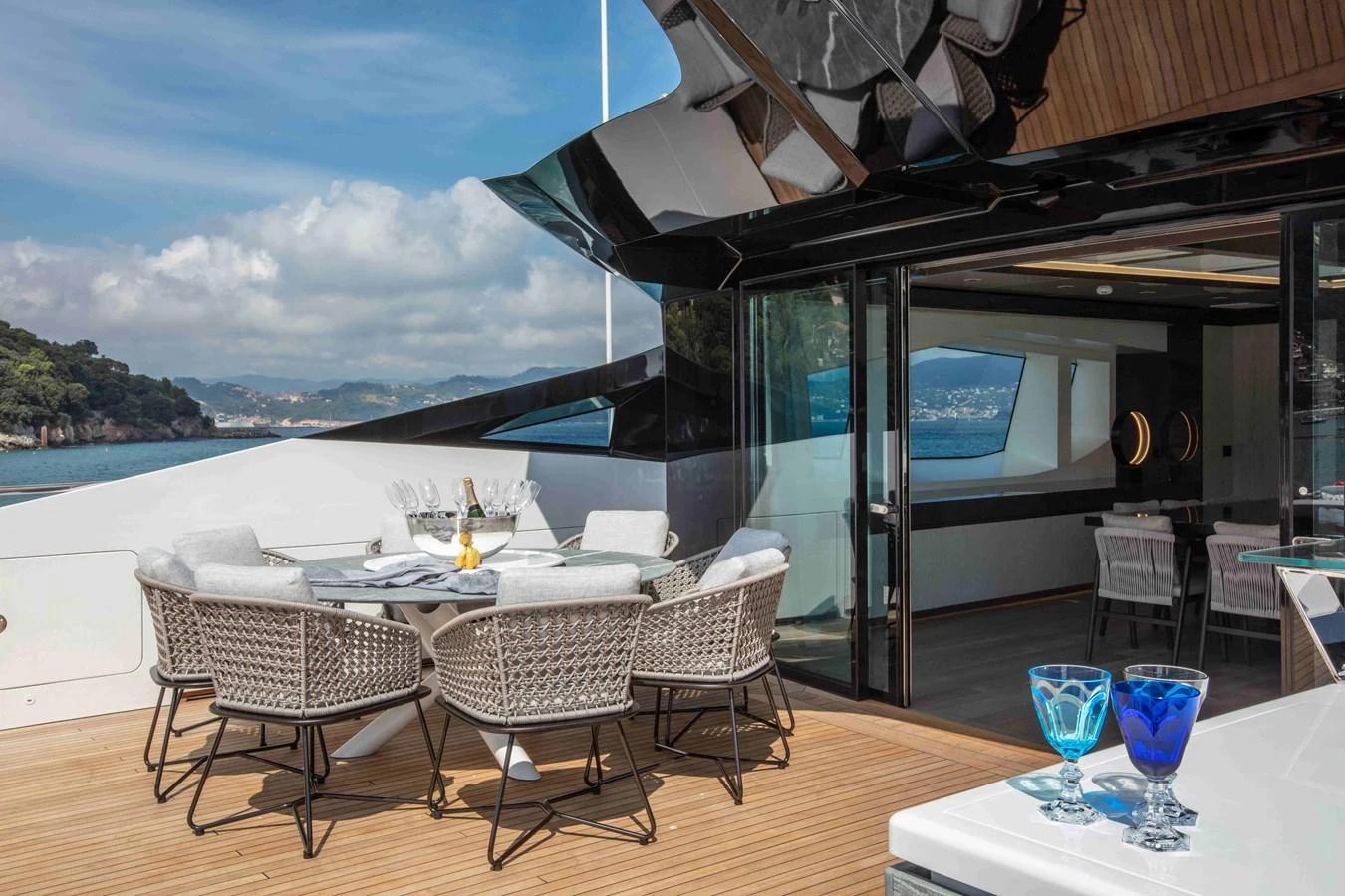 a table and chairs on a deck aboard MA Yacht for Sale