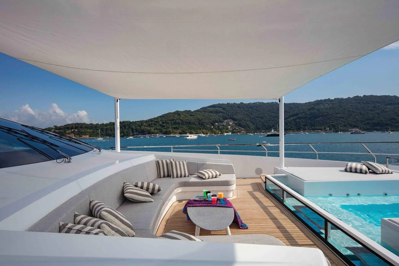 a large pool with a deck and a view of the ocean aboard MA Yacht for Sale