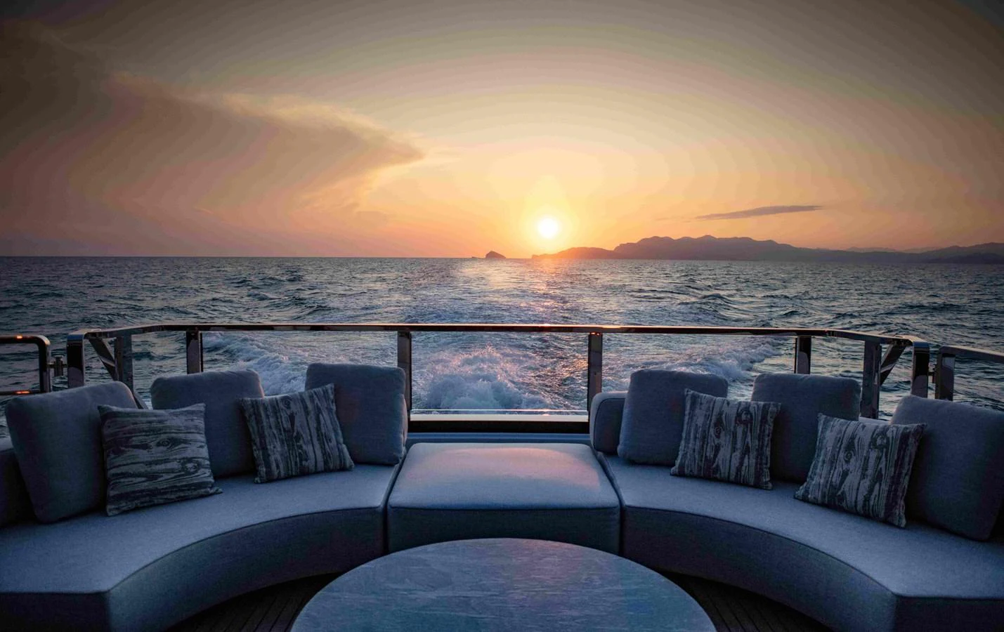 a large blue couch overlooking a large body of water aboard MA Yacht for Sale