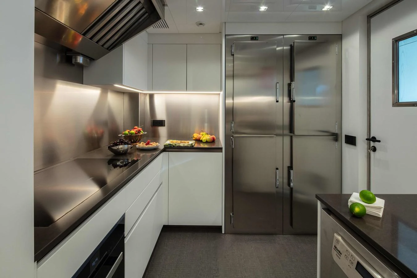 a kitchen with white cabinets aboard MA Yacht for Sale