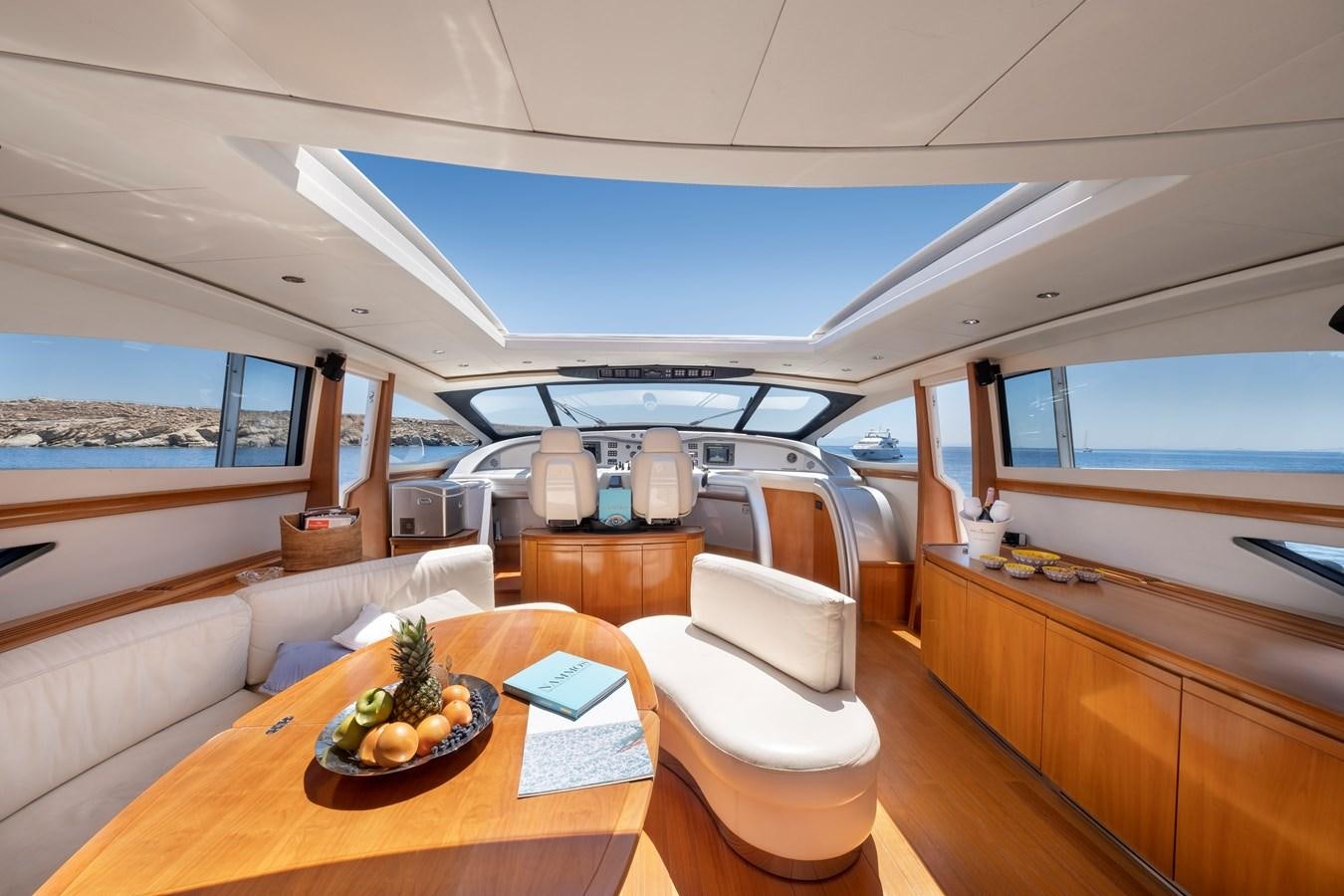 a room with a table and chairs aboard ICE Yacht for Sale