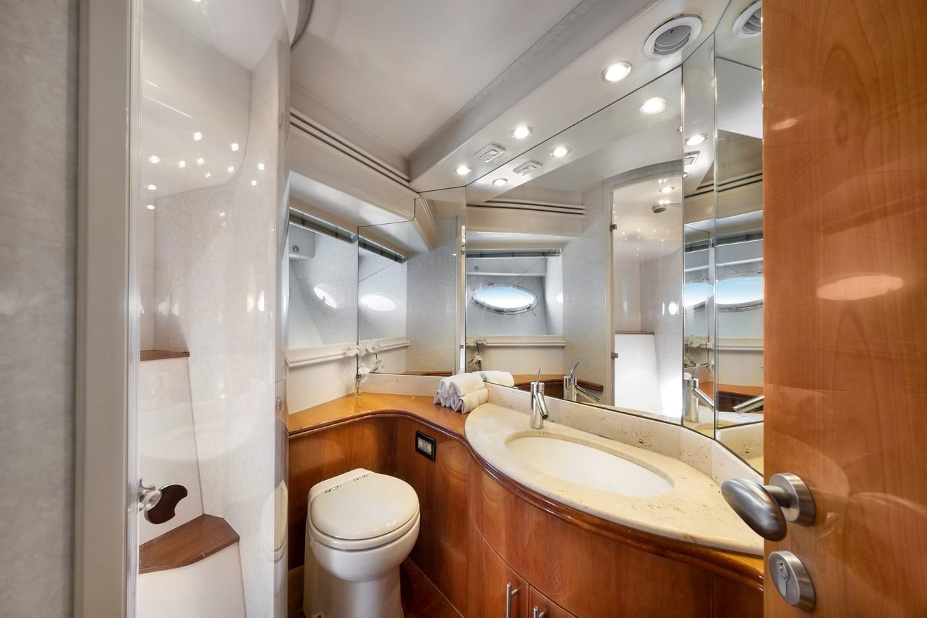 a bathroom with a sink toilet and a mirror aboard ICE Yacht for Sale