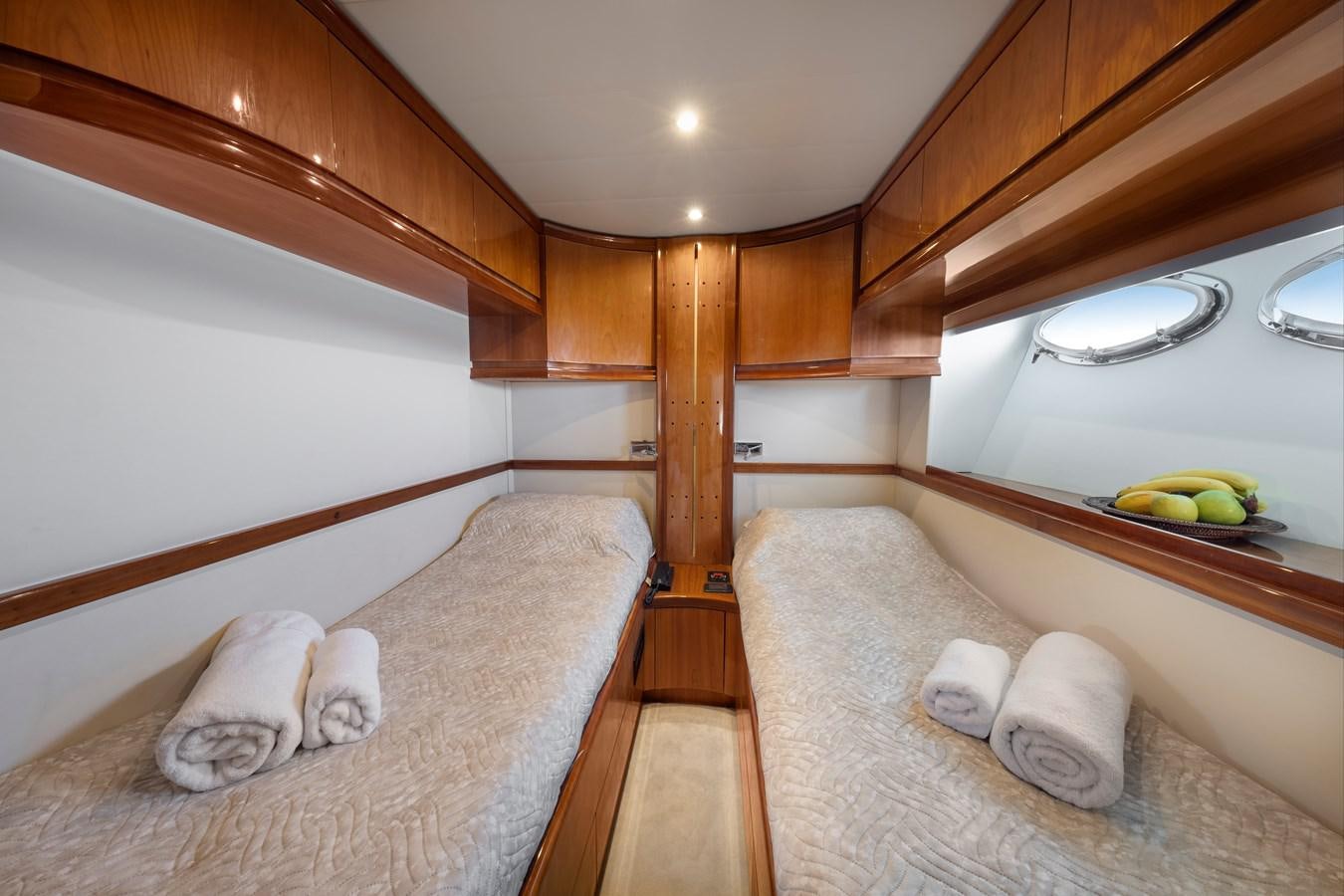 a room with wooden walls and a couple of beds aboard ICE Yacht for Sale