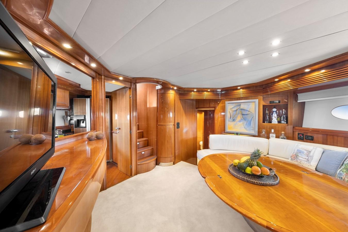 a large living room with a large mirror aboard ICE Yacht for Sale