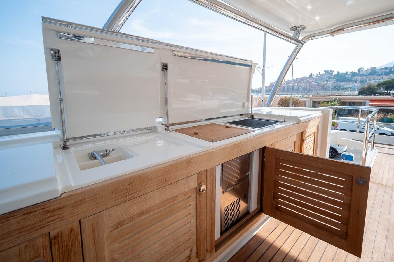 a kitchen with a large white refrigerator aboard CHARISMA Yacht for Sale