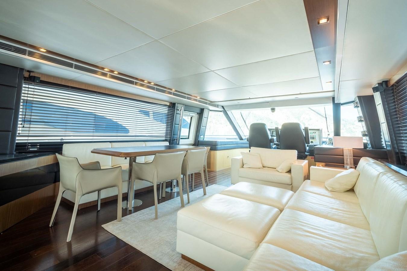 a room with a table chairs and a couch aboard CHARISMA Yacht for Sale