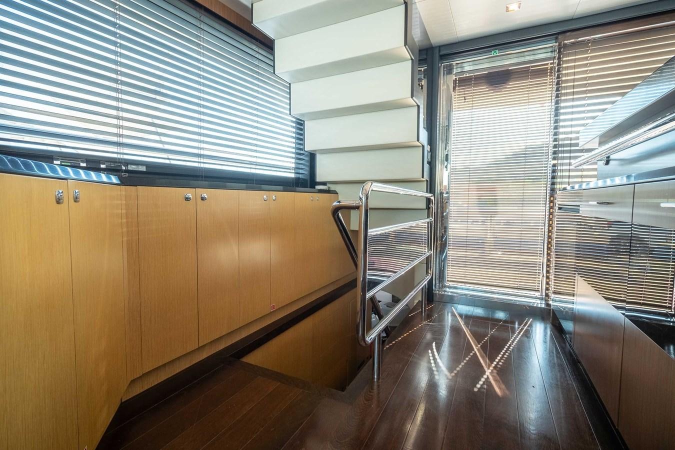 a room with wooden floors and a staircase aboard CHARISMA Yacht for Sale