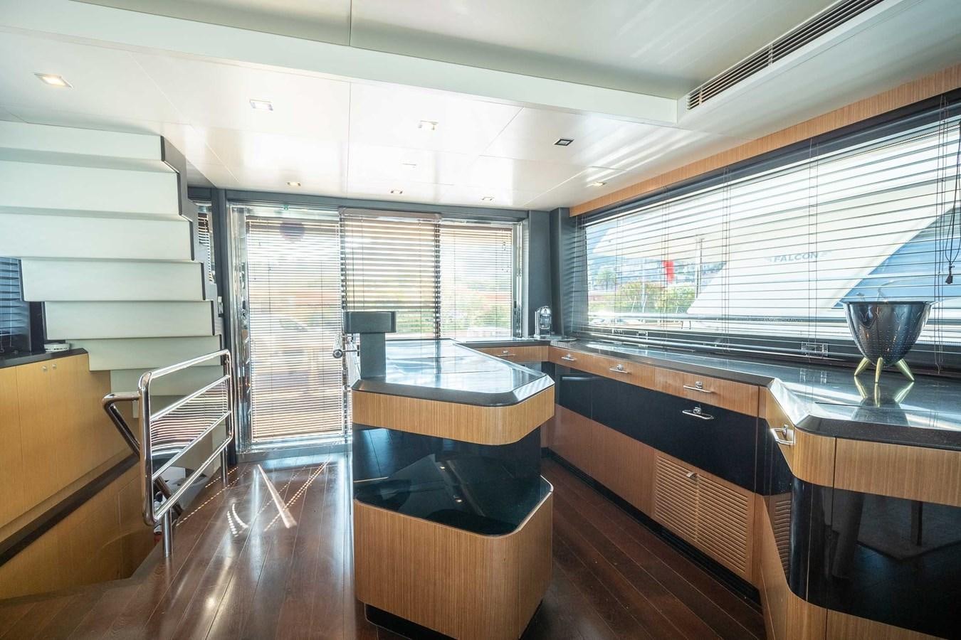 a room with a large window and a table with chairs aboard CHARISMA Yacht for Sale