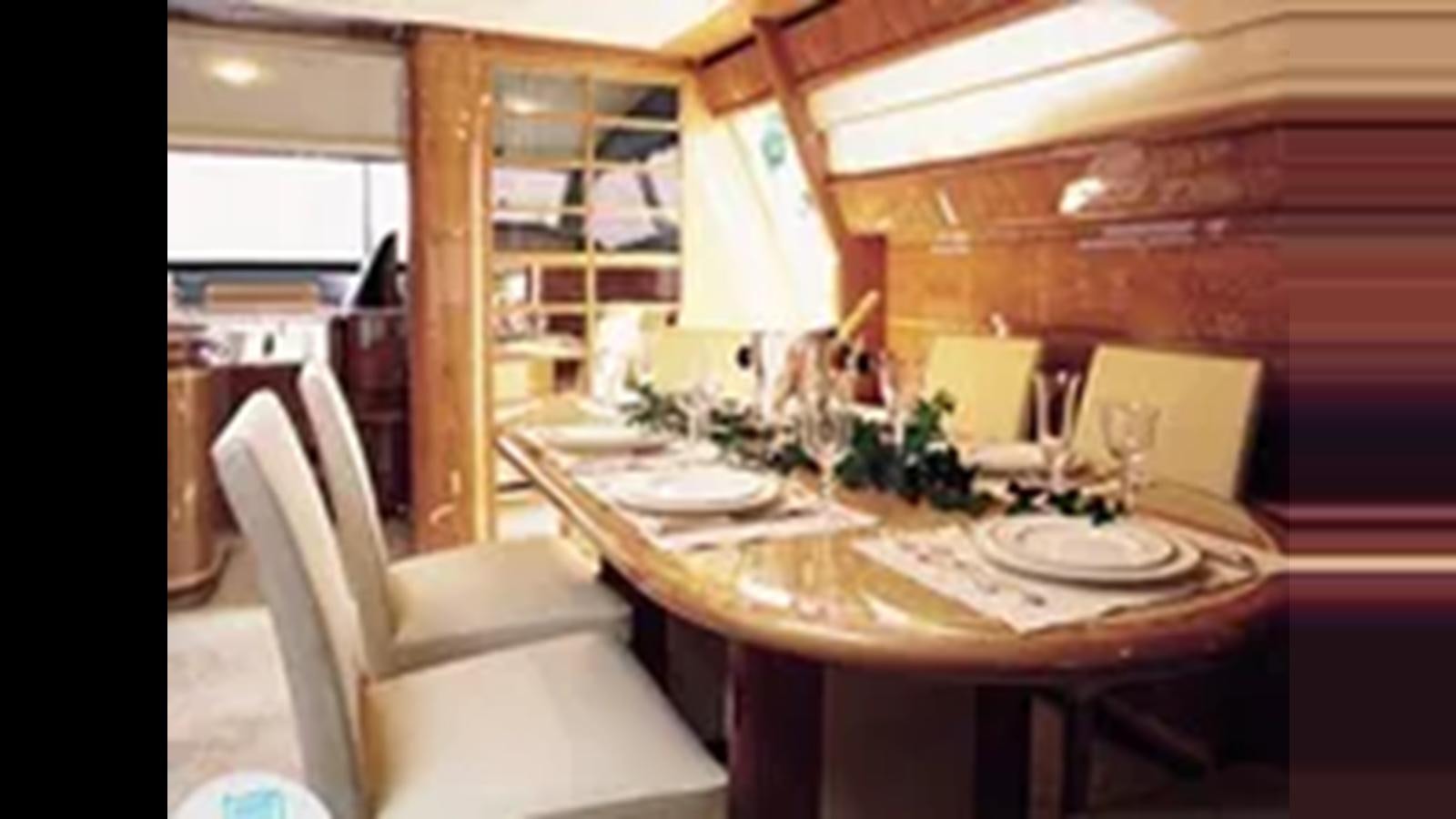 a dining table with glasses aboard 2004 FERRETTI YACHTS 810 Yacht for Sale