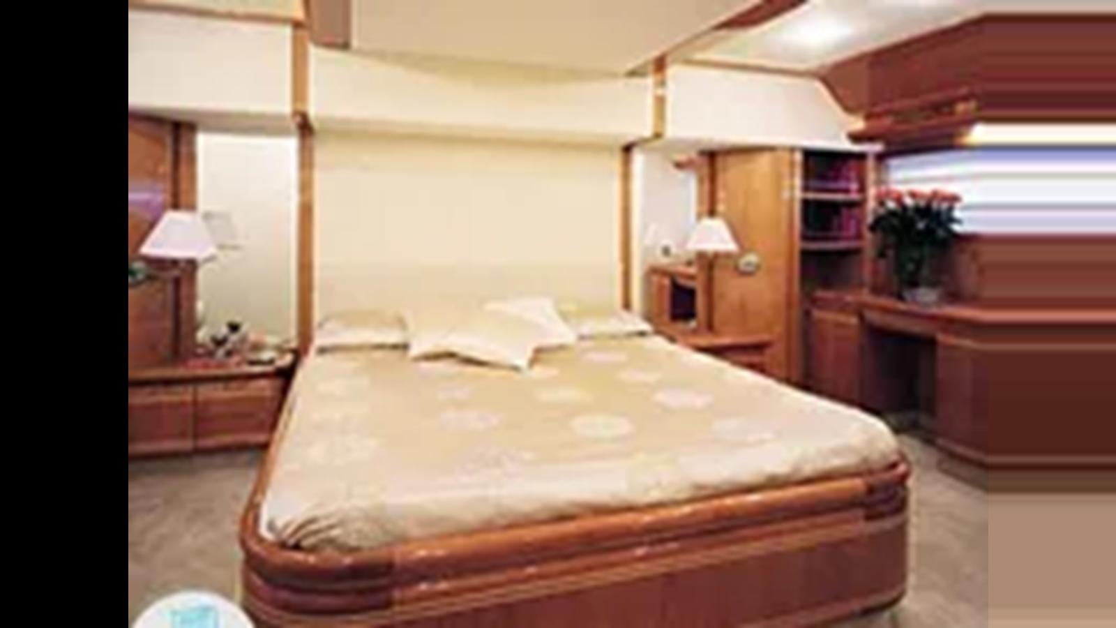 a bedroom with a bed and a desk aboard 2004 FERRETTI YACHTS 810 Yacht for Sale