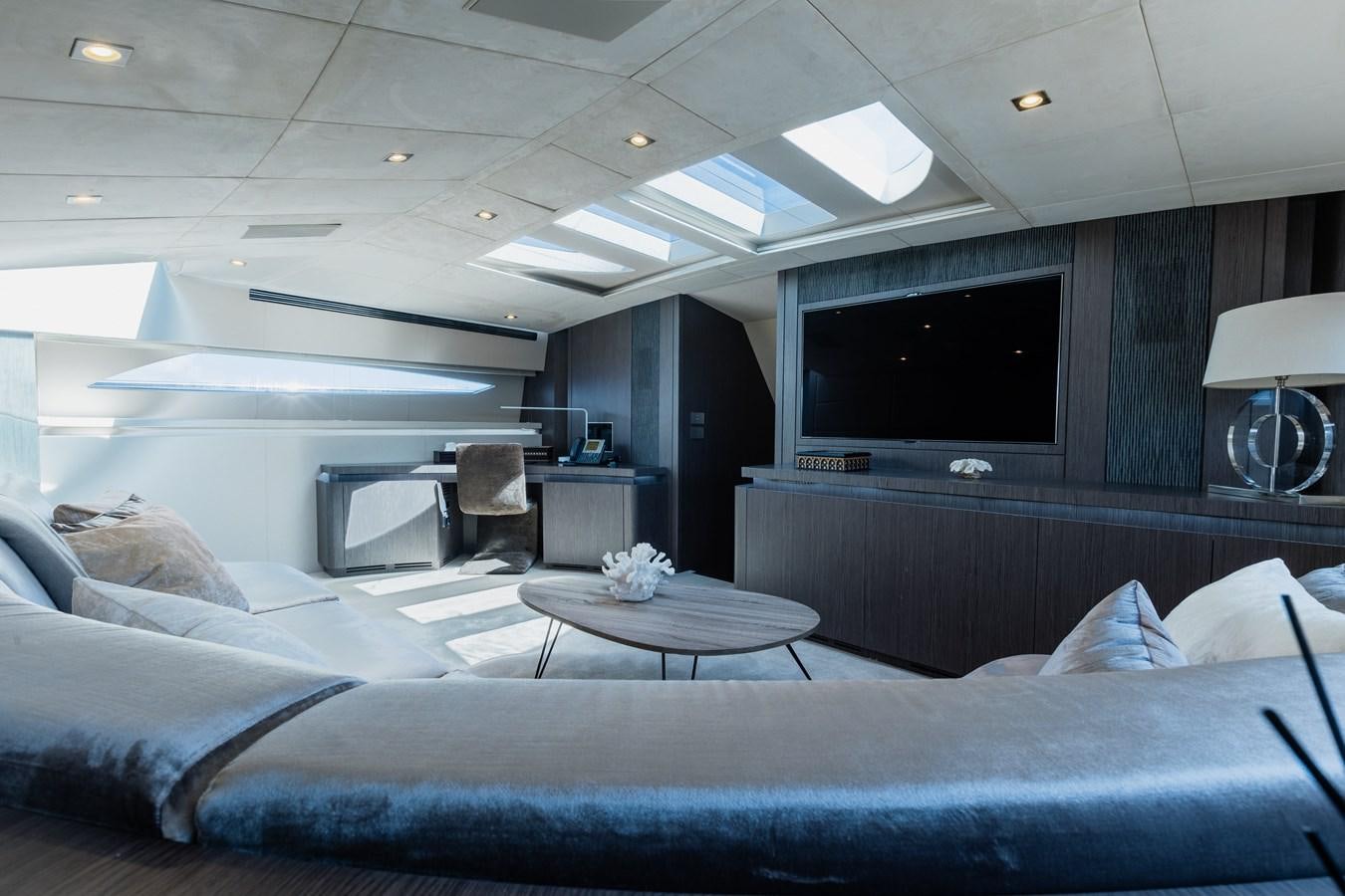 a room with a couch and a television aboard KOLAHA TWO Yacht for Sale