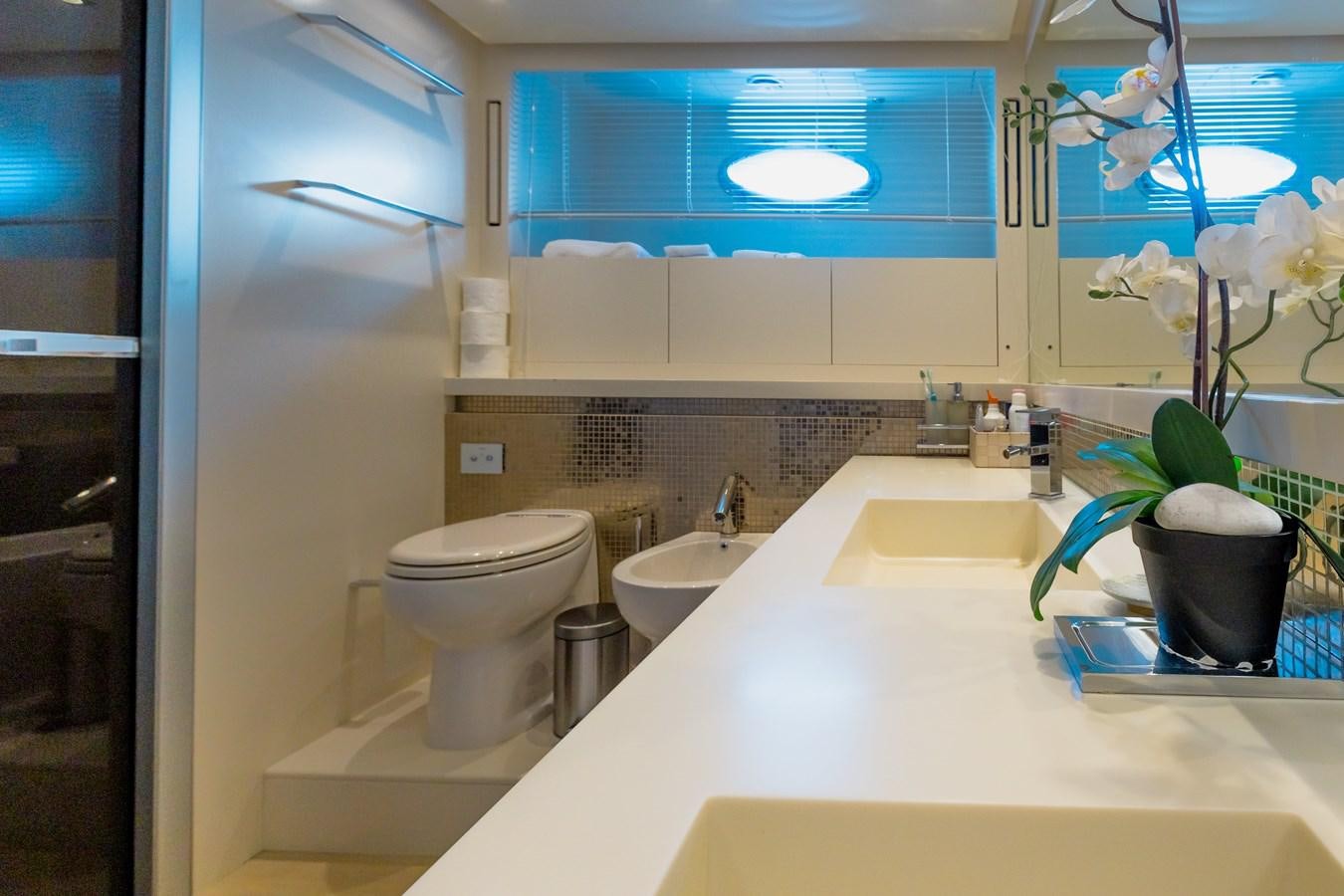 a bathroom with a tub sink and toilet aboard KOLAHA TWO Yacht for Sale