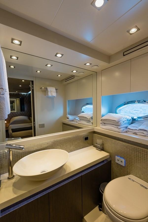 a bathroom with a large mirror aboard KOLAHA TWO Yacht for Sale