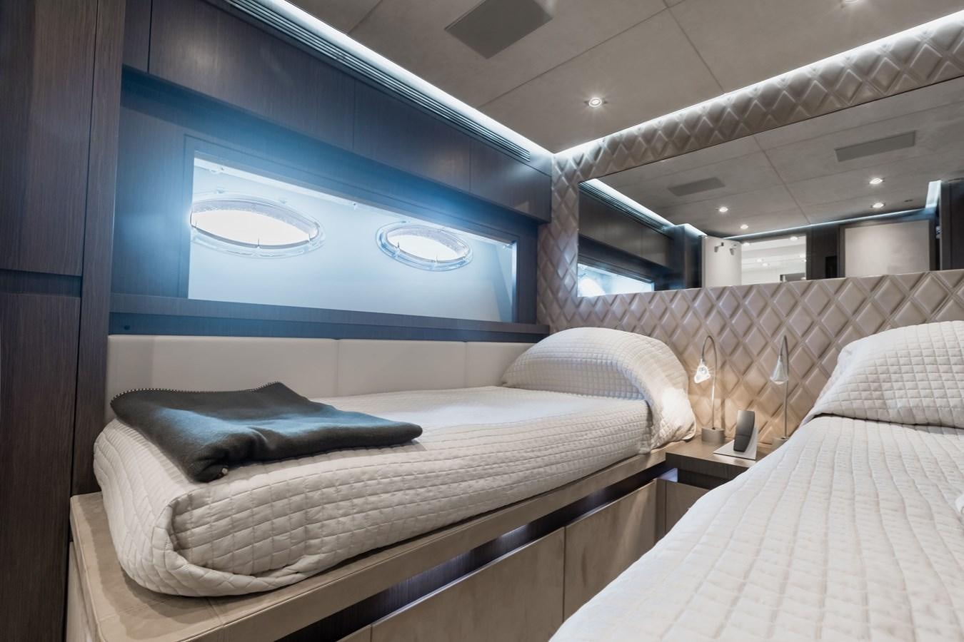 a room with beds and a large window aboard KOLAHA TWO Yacht for Sale