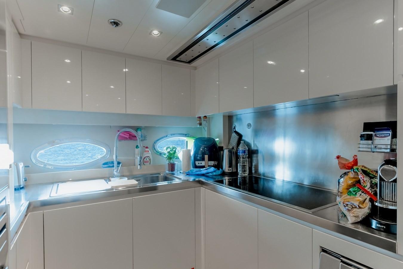 a kitchen with a sink and a bowl of food aboard KOLAHA TWO Yacht for Sale