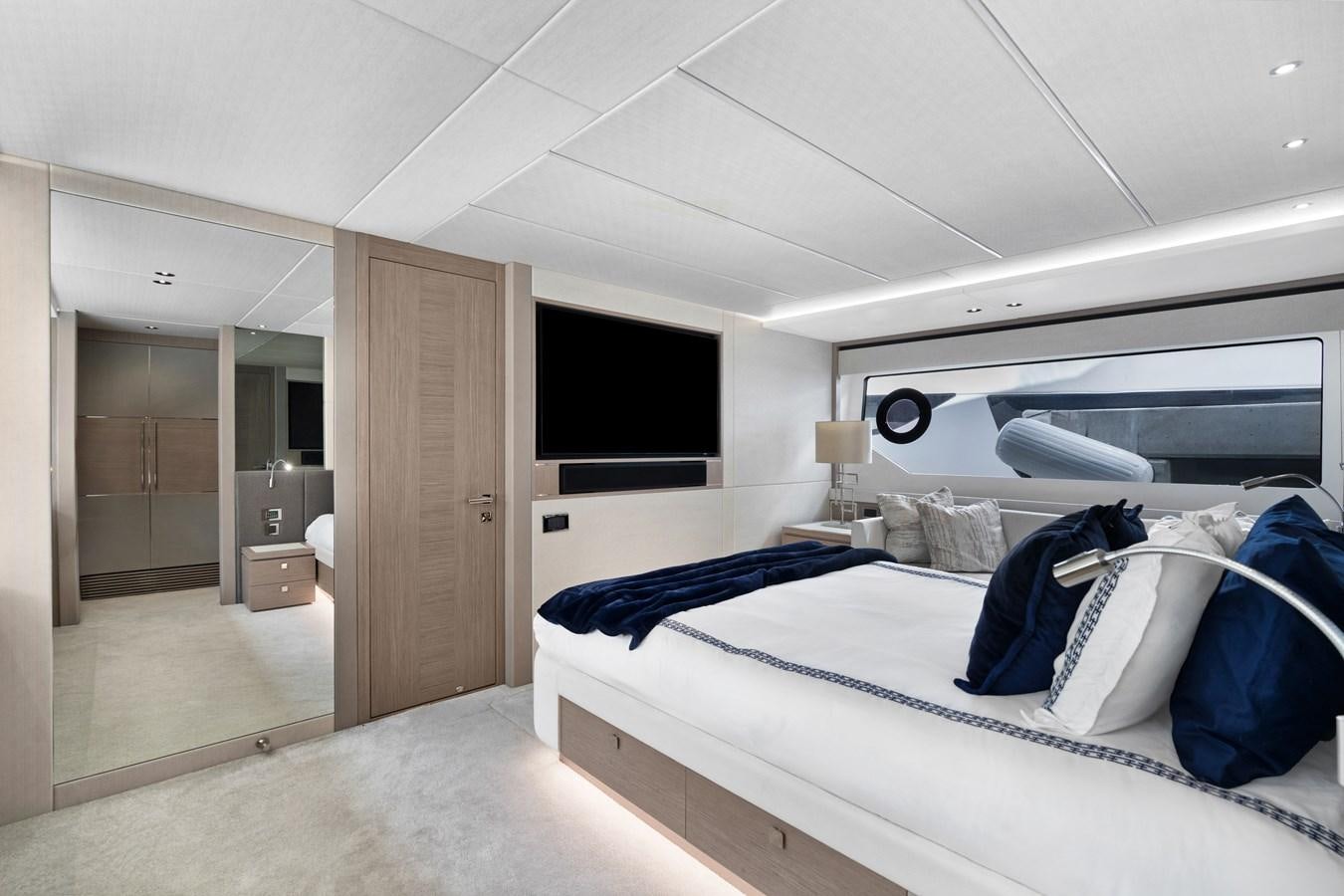 a room with a bed and a television aboard MILAMO Yacht for Sale