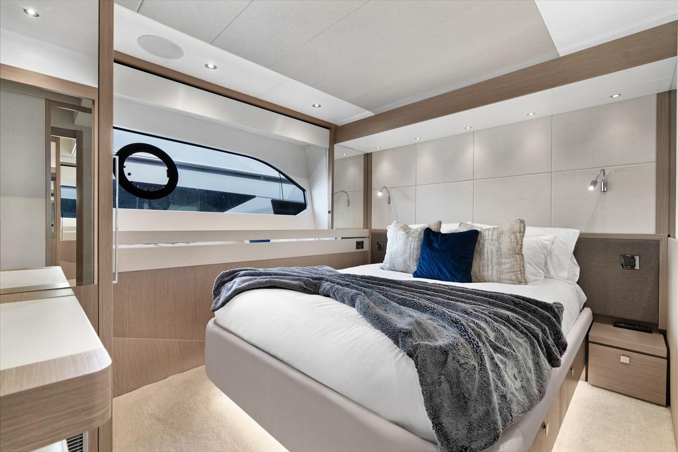 a bedroom with a bed and a desk aboard MILAMO Yacht for Sale