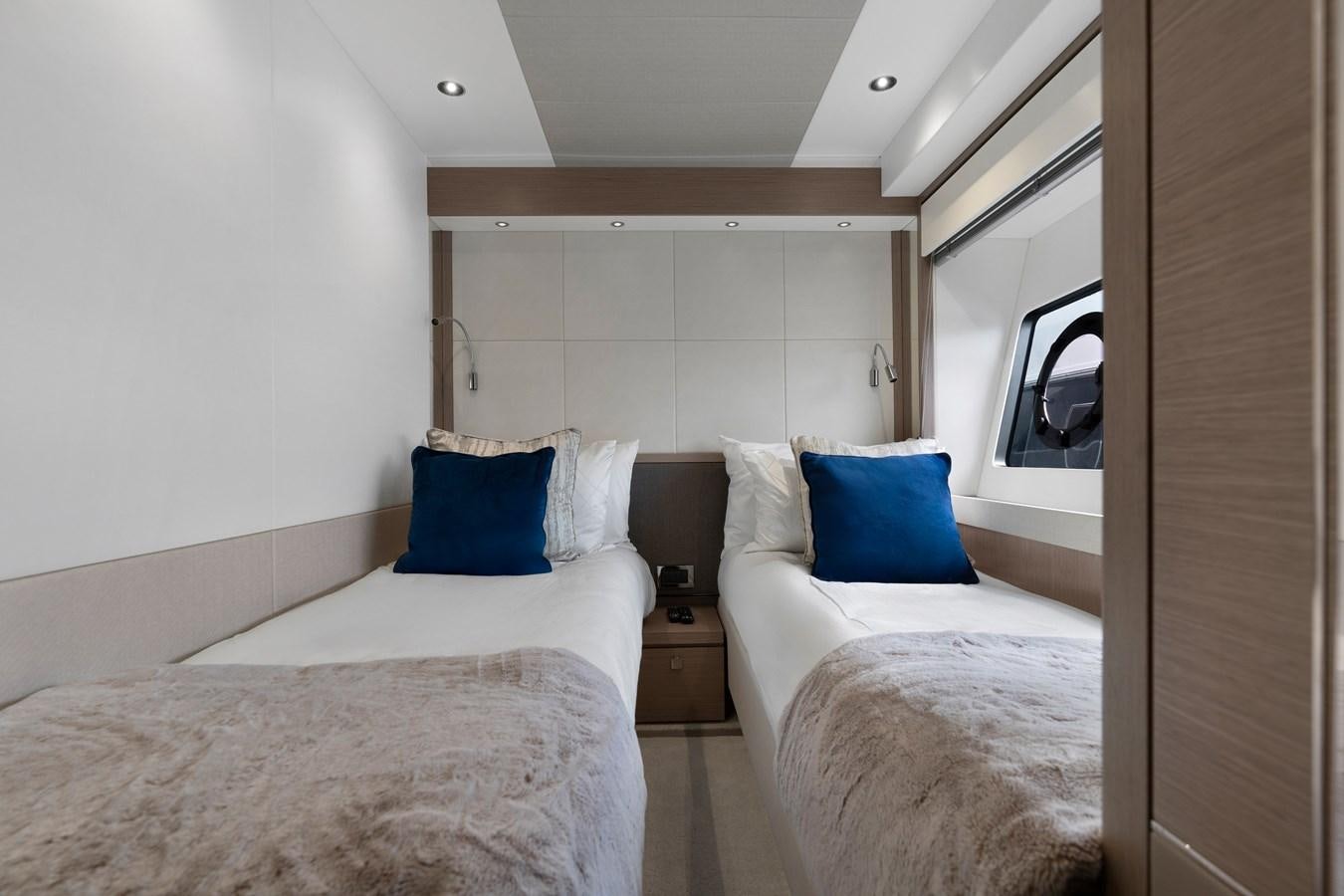 a room with two beds aboard MILAMO Yacht for Sale