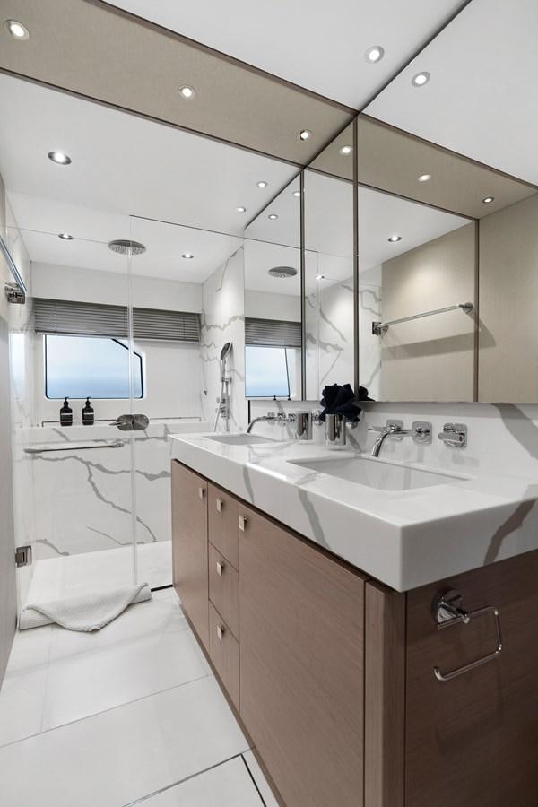 a bathroom with a sink and a mirror aboard MILAMO Yacht for Sale