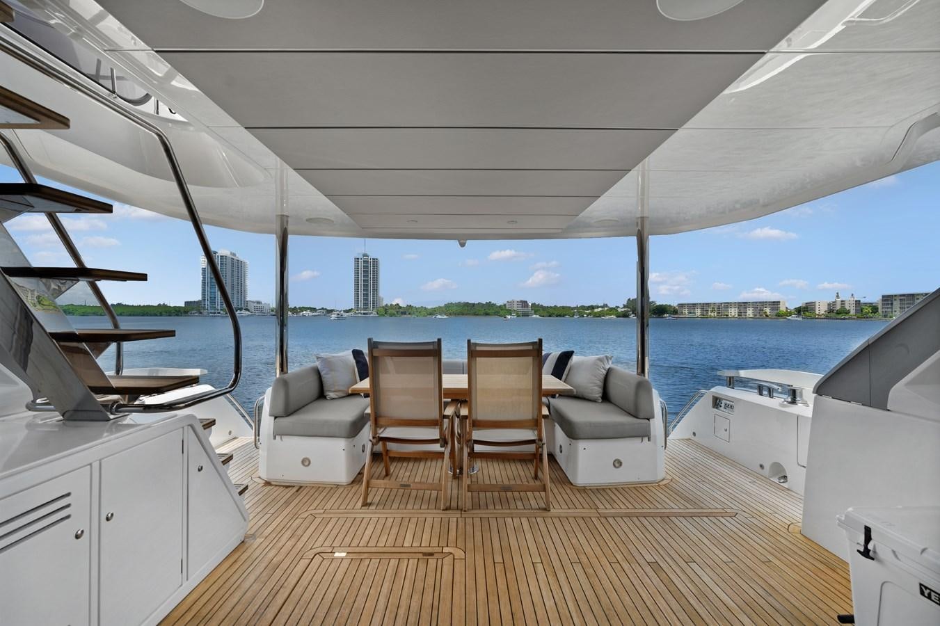 a room with a view of the water and a city aboard MILAMO Yacht for Sale