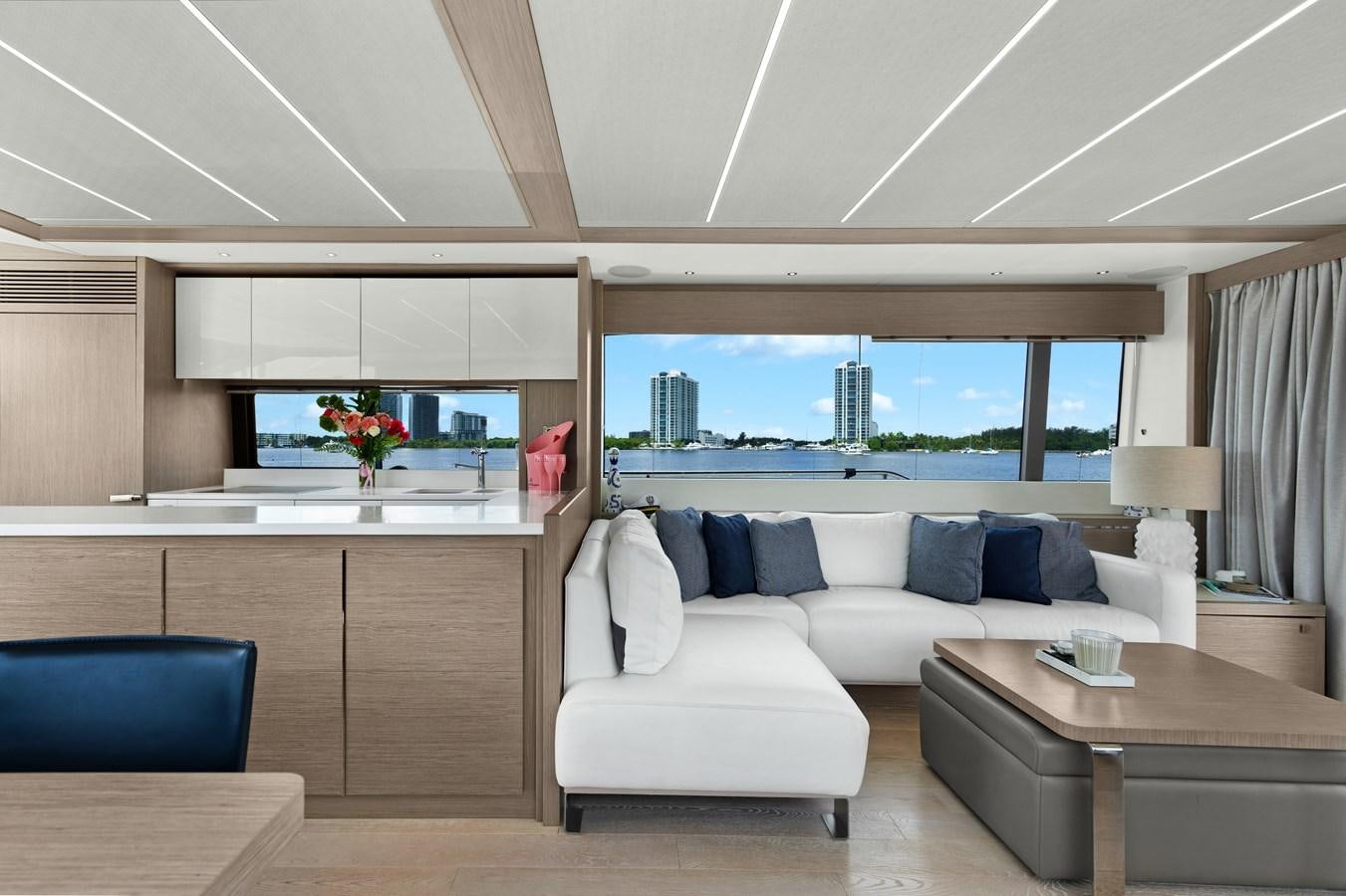 a living room with a large window aboard MILAMO Yacht for Sale