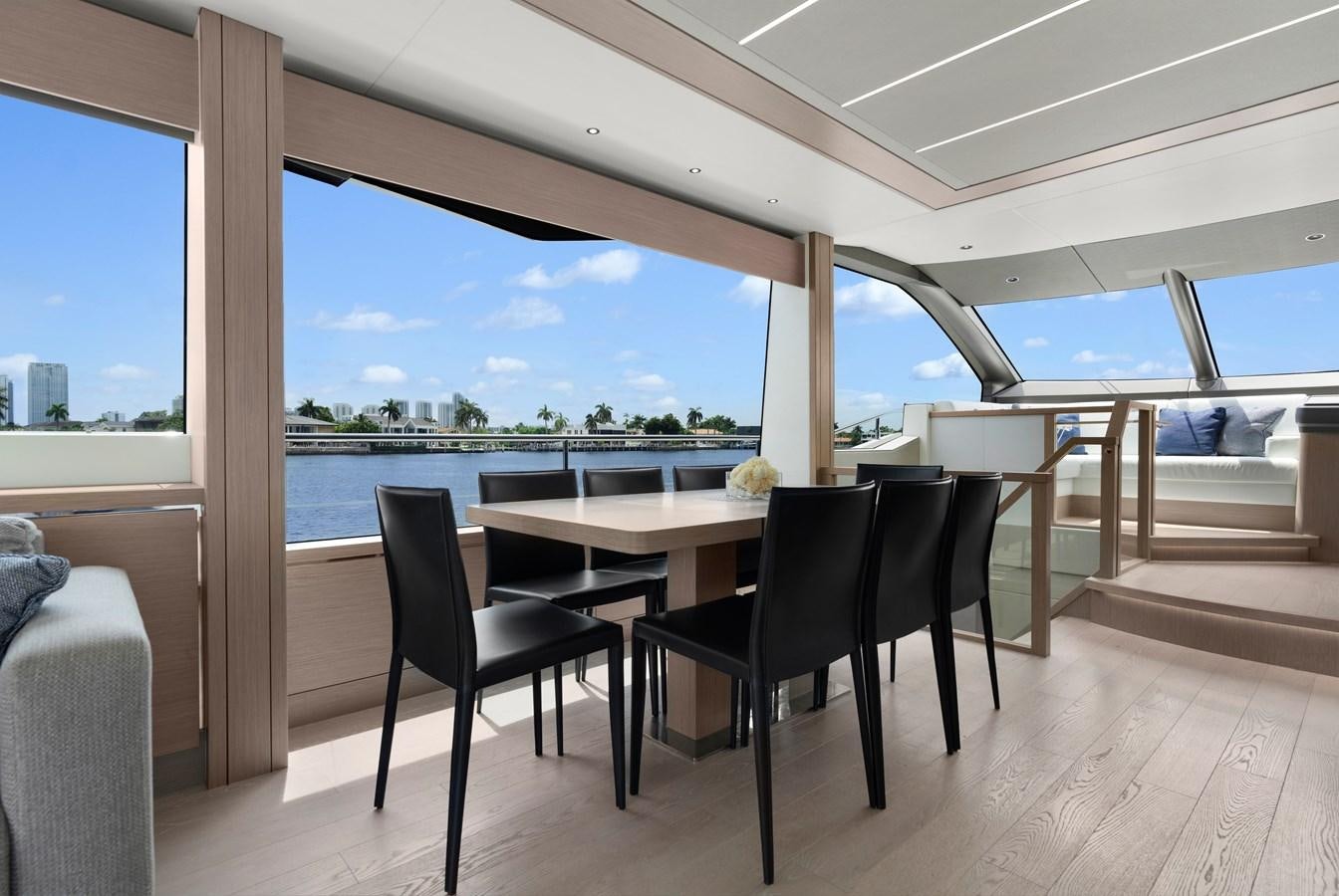 a table and chairs on a deck aboard MILAMO Yacht for Sale