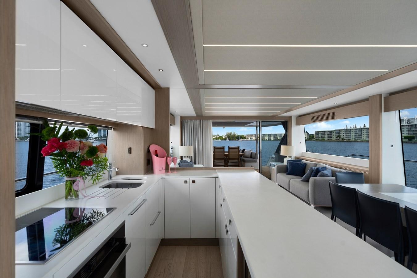 a kitchen with a table and chairs aboard MILAMO Yacht for Sale