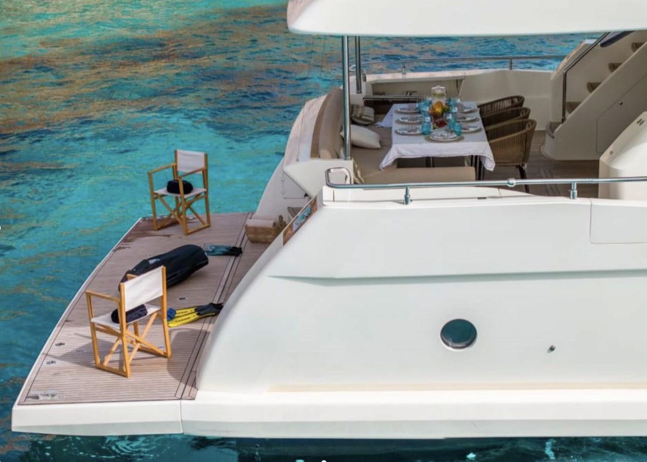 a boat with a table and chairs on the deck aboard BYSCAINE Yacht for Sale
