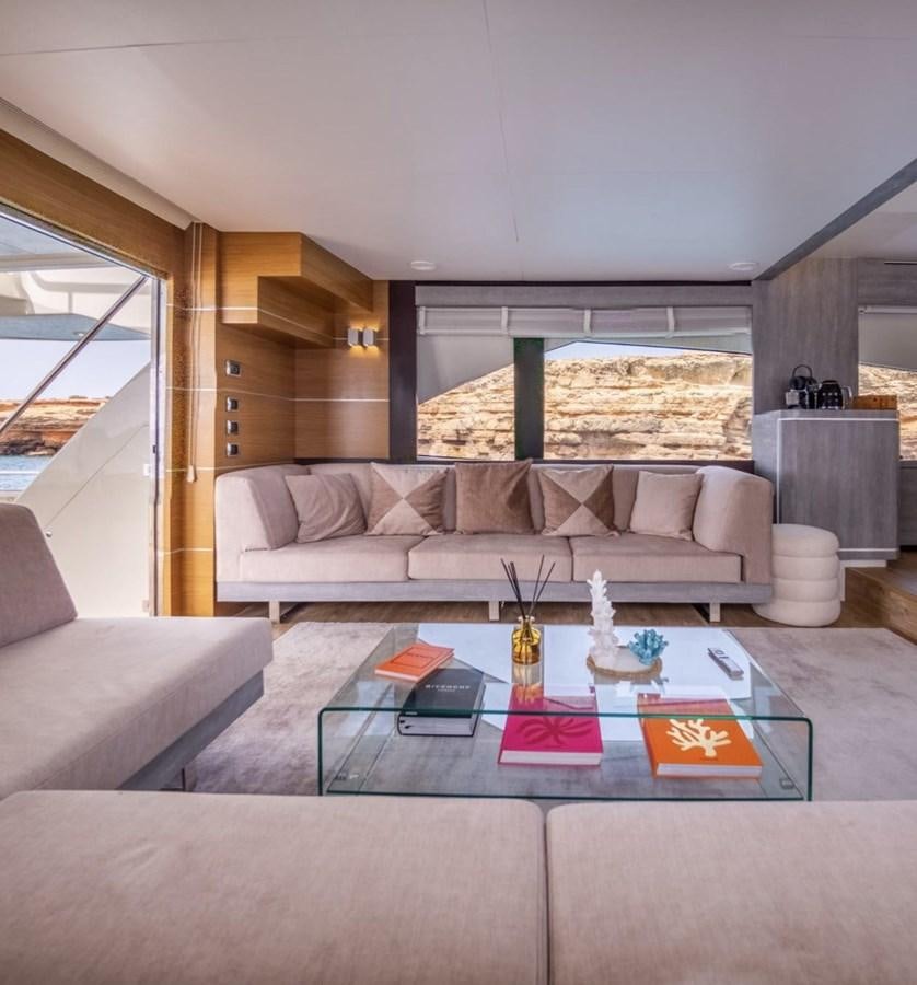 a living room with a couch and a coffee table aboard BYSCAINE Yacht for Sale