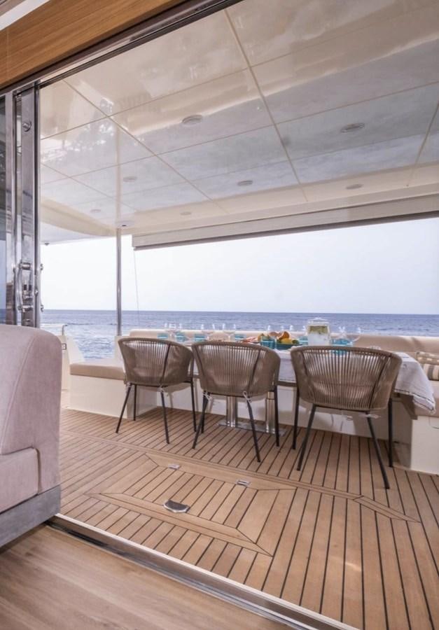 a room with a table and chairs aboard BYSCAINE Yacht for Sale