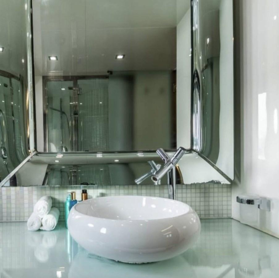 a bathroom sink with a large mirror aboard BYSCAINE Yacht for Sale