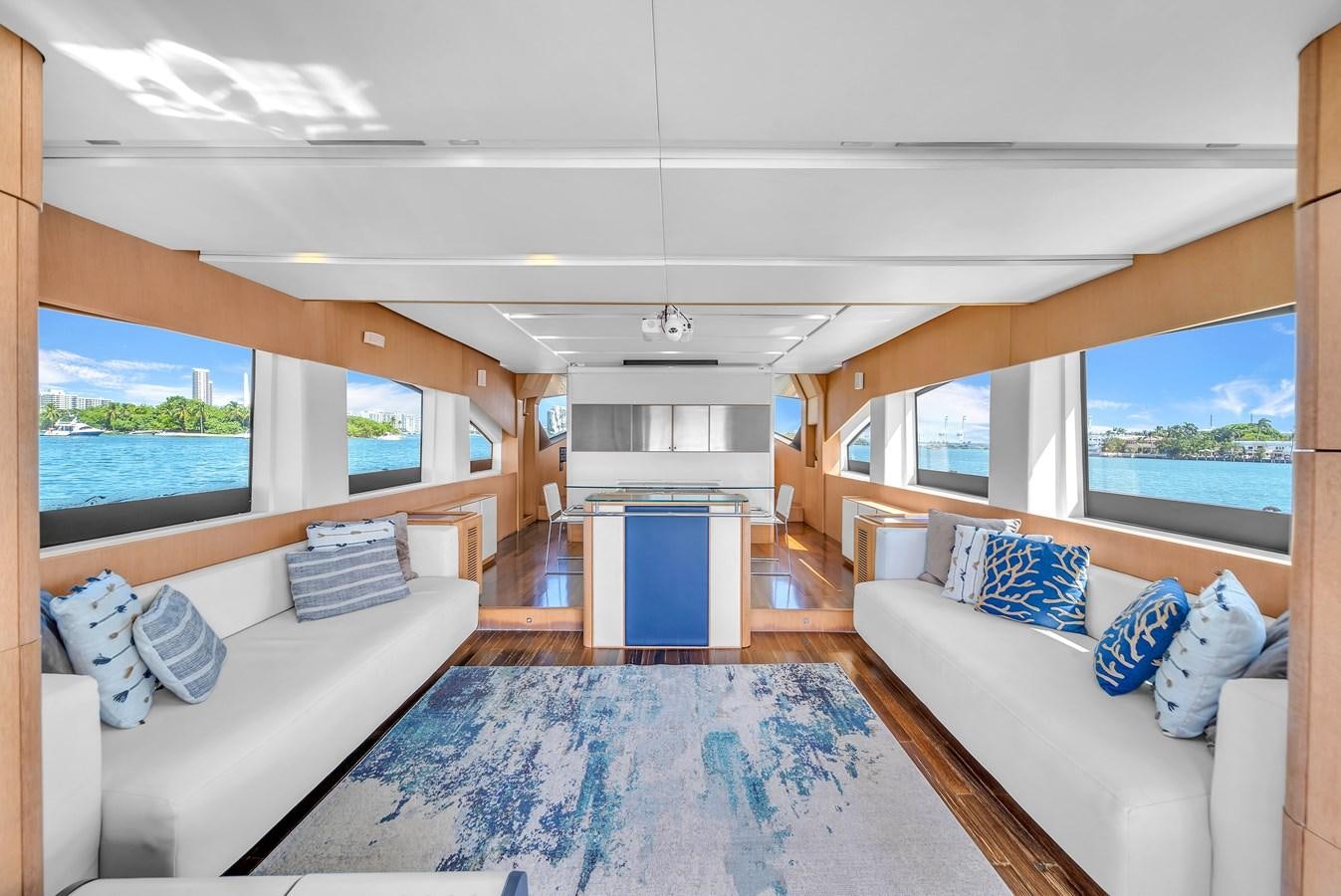 a living room with a large blue rug and a large blue rug aboard AICON 85 Yacht for Sale